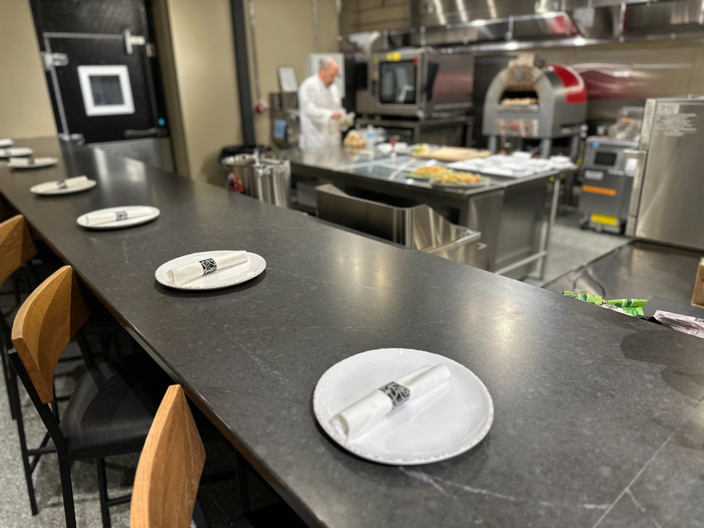 Close-up of place settings at the culinary tasting counter at Revelance Mason Ohio — private chef dinner setup