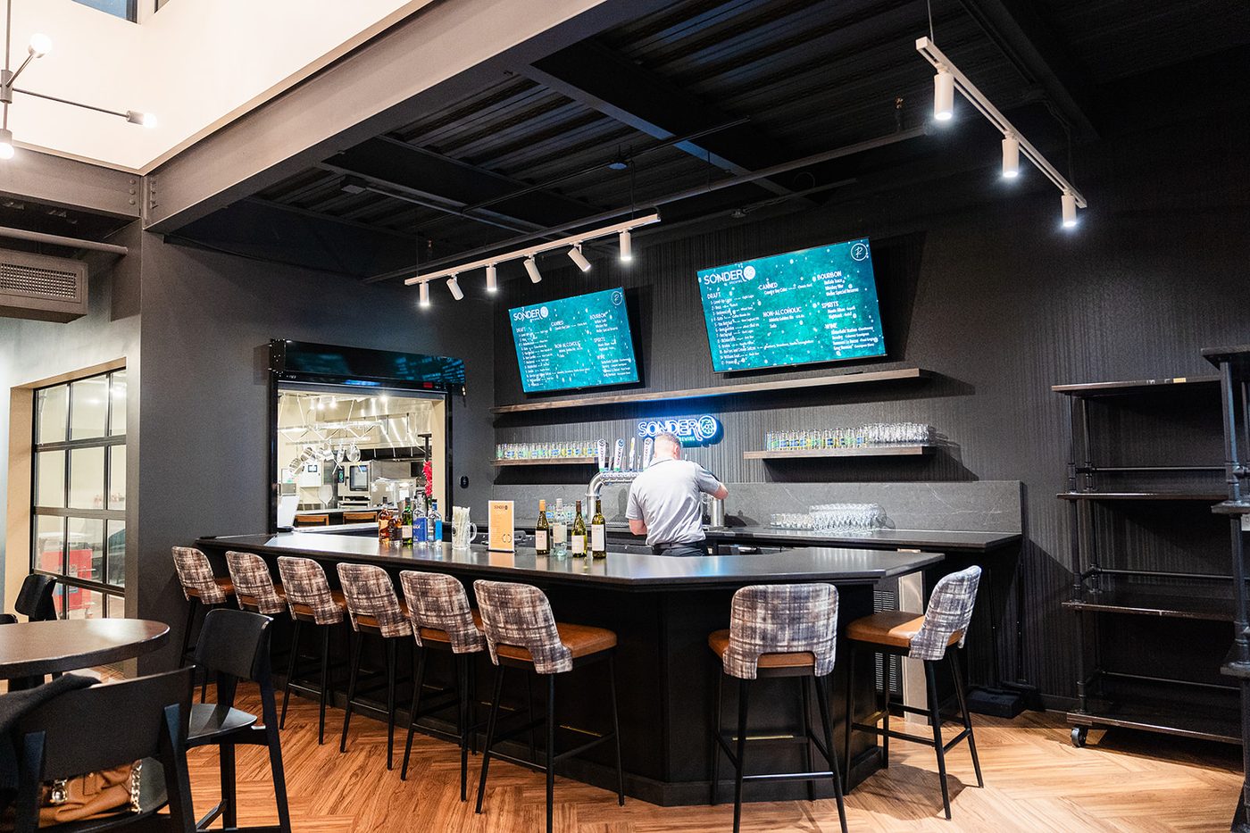 The Taproom full bar at Revelance with Sonder Brewing taps and menu screens